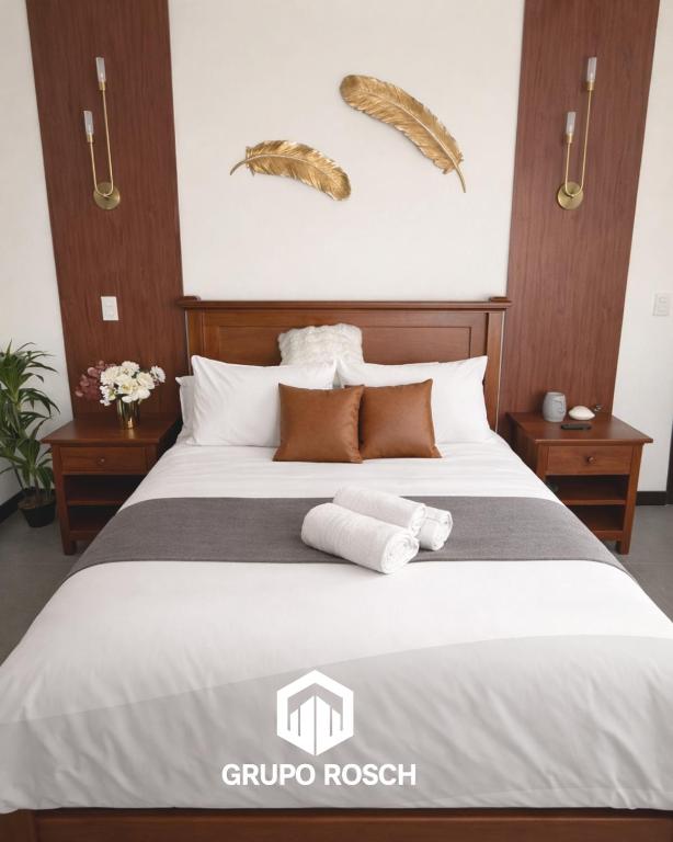 a bedroom with a bed with two towels on it at Apartamento con Piscina in Las Victorias