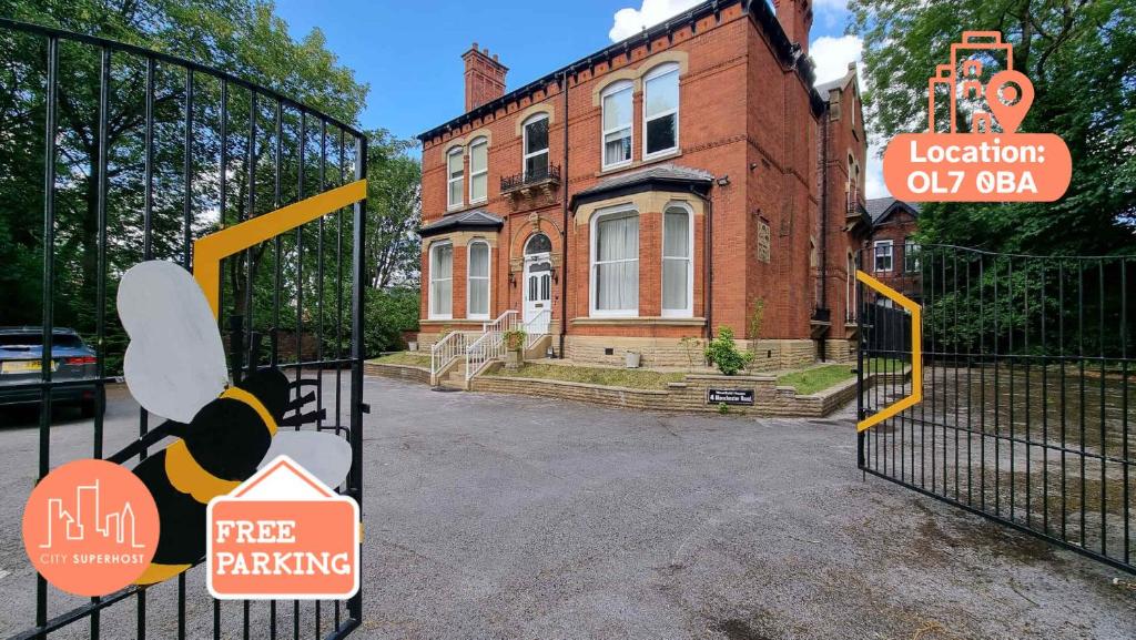 a gate with a teddy bear on it in front of a house at 6 Bed Mansion Sleeps 20 Free Parking in Ashton under Lyne