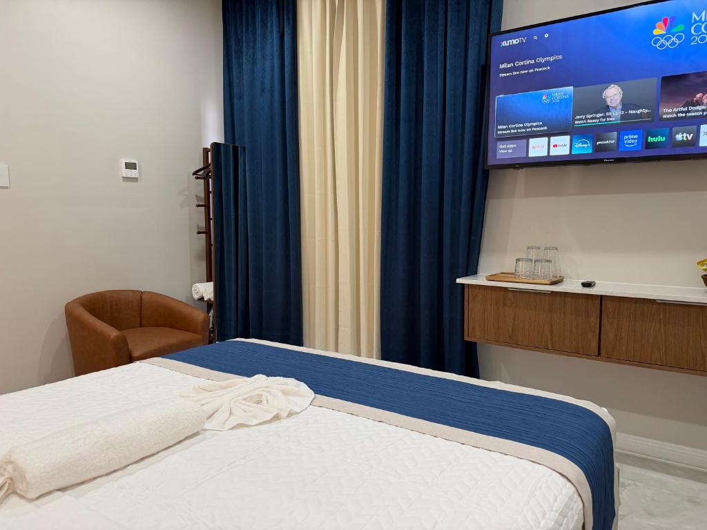 a hotel room with a bed and a flat screen tv at Sanrai in Gros Islet