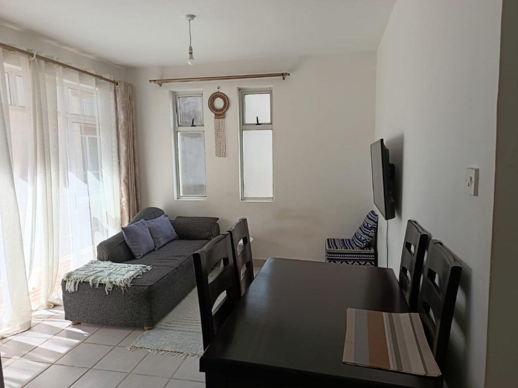 a living room with a couch and a table at Nyumbani in Nairobi