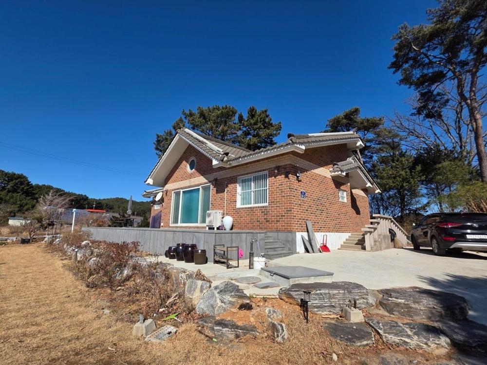a brick house with a driveway in front of it at Mooldan Dongsan Taean in Taean
