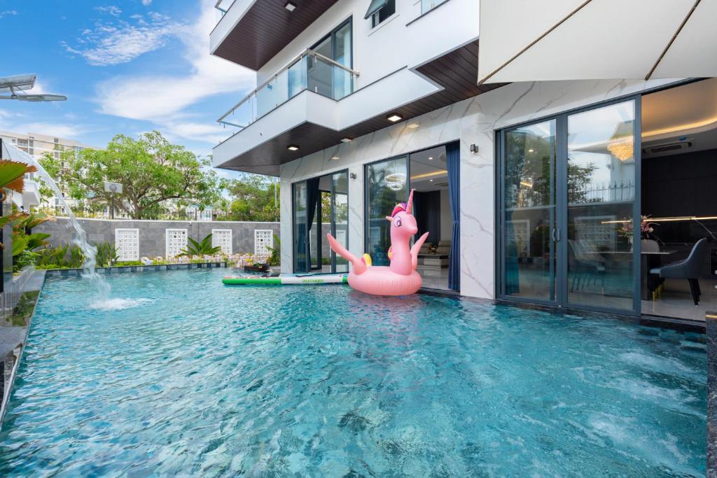 a pool with a pink inflatable flamingo in a house at Villa B2-34 Long Cung in Vung Tau