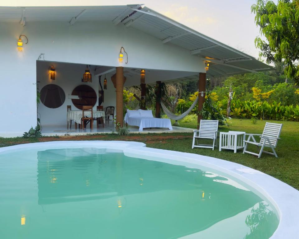 a swimming pool in front of a house at Ceylon Marley Villa in Talawa