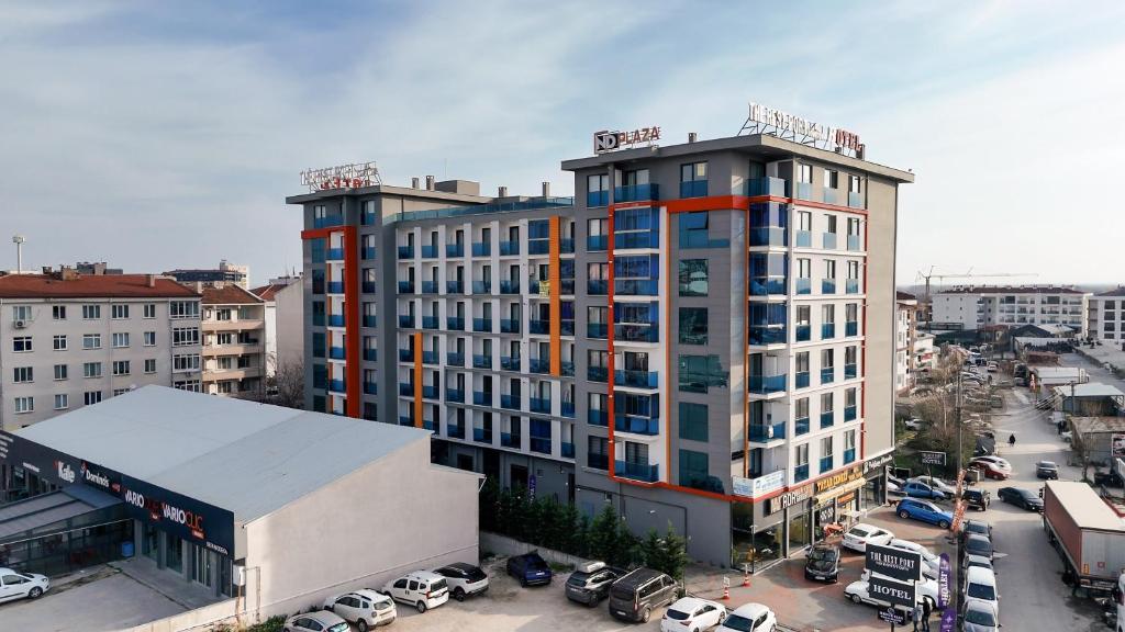 a tall building in a city with a parking lot at The Rest Port Nd Downtown in Edirne