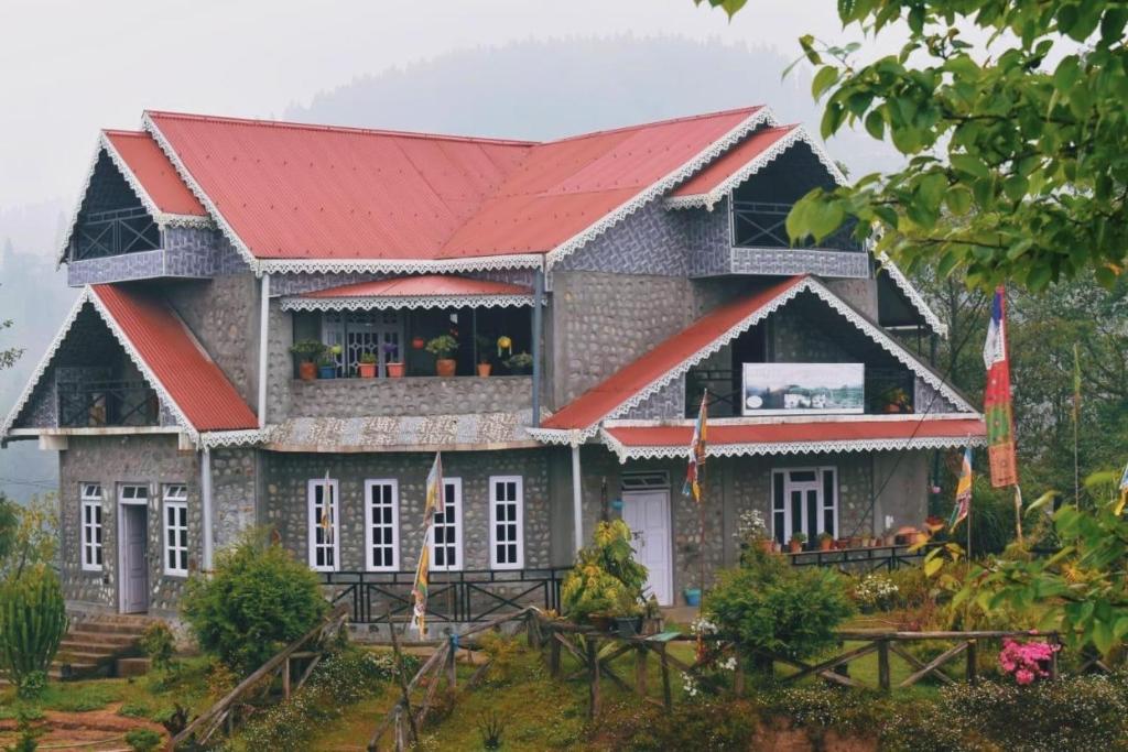a house with a red roof at Manjosila Homestay in Mirik