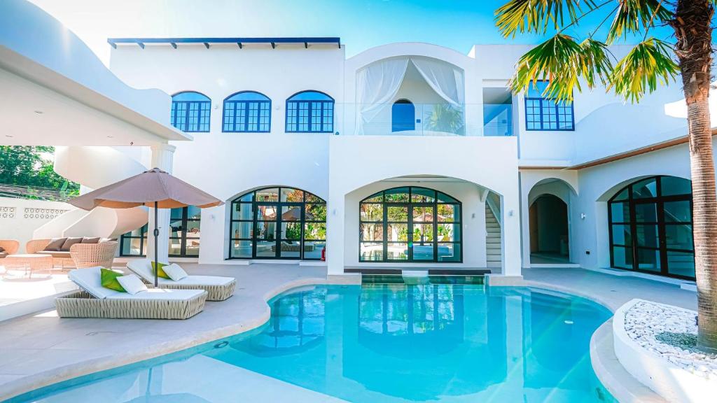 an exterior view of a villa with a swimming pool at Grand De Raj in Angeles