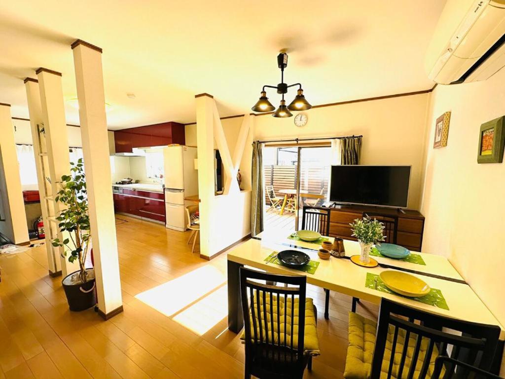 a kitchen and dining room with a table and chairs at 清場Kiyoba in Kawaguchi