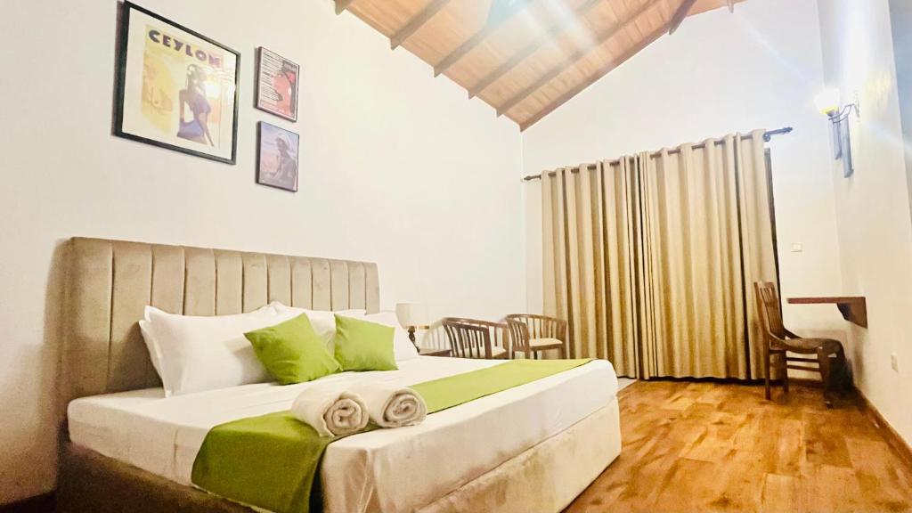 a bedroom with a bed with towels on it at Mara Villa Katunayake - 5 Mins to Colombo Airport in Katunayaka