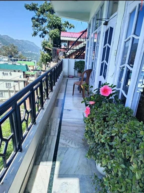 a balcony with a bench and flowers on a building at Harmony Homestay Couple & Family friendly prime location Easy access to Mall Rd -City view in Solan