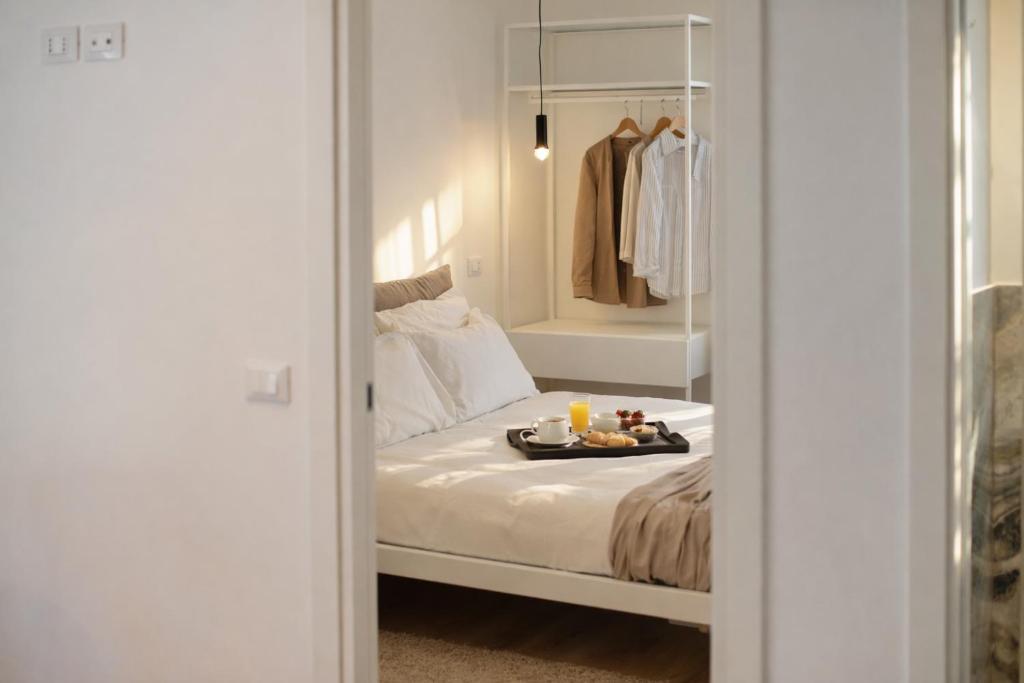 a bedroom with a bed with a tray of food on it at Residenza Ximenes Hub in Palermo