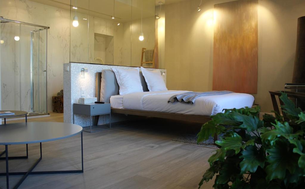 a bedroom with a large bed and a table at Les Suites Massena in Nice