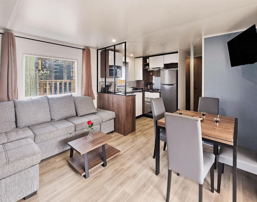 a living room with a couch and a table at Le Coin Chill in Litteau