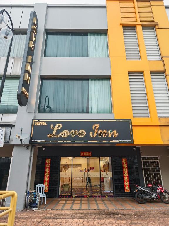 a store front of a building with a sign on it at Love Inn Hotel Kuchai Lama in Kuala Lumpur