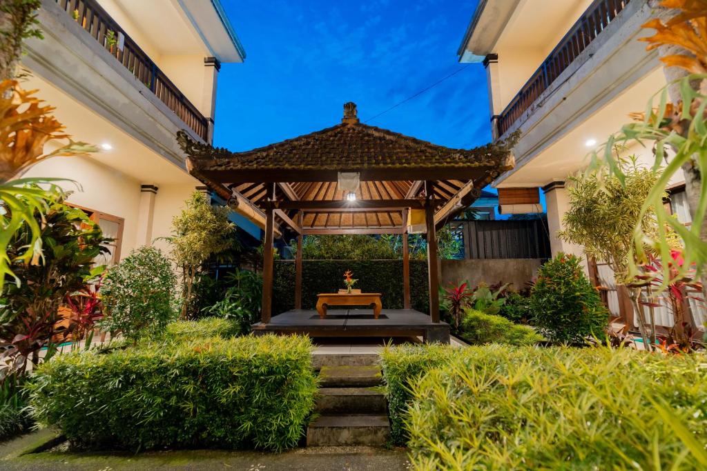 a gazebo in the courtyard of a house at Umah Gatra Ubud in Ubud