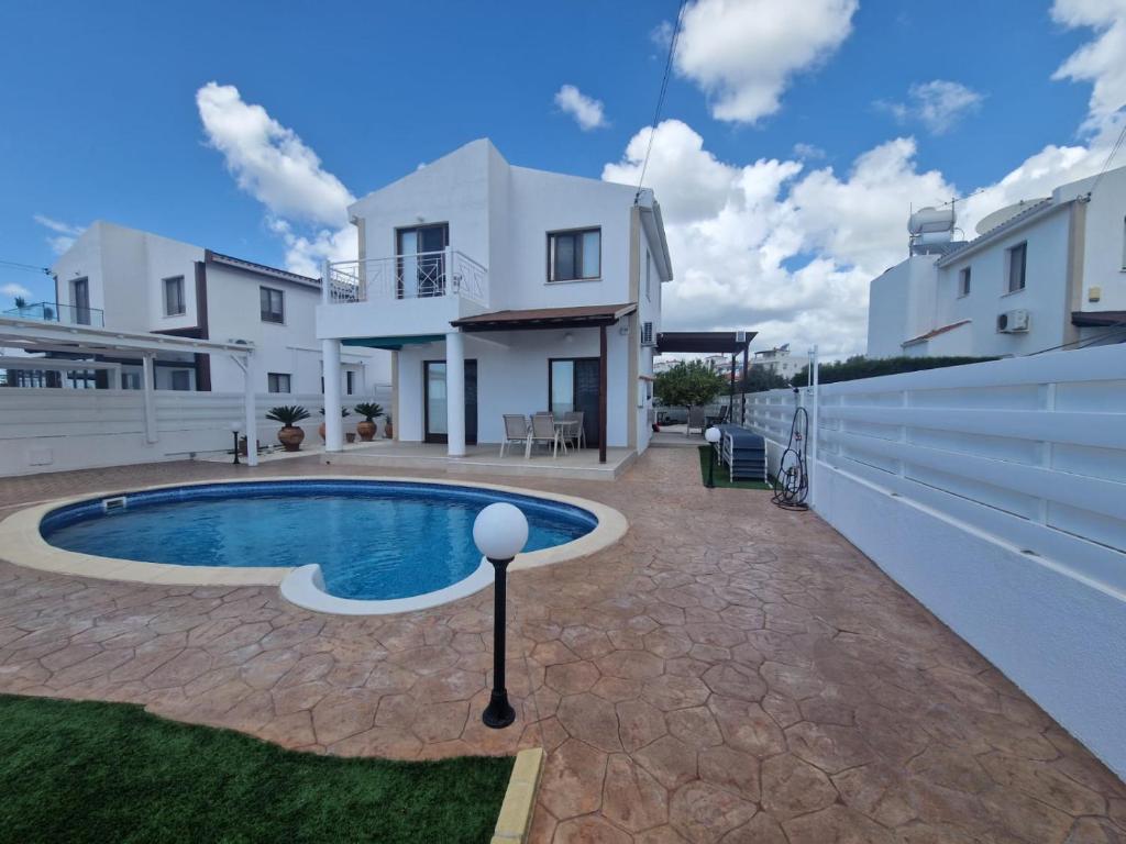 a villa with a swimming pool and a house at Marmario Villa 10 in Anarita
