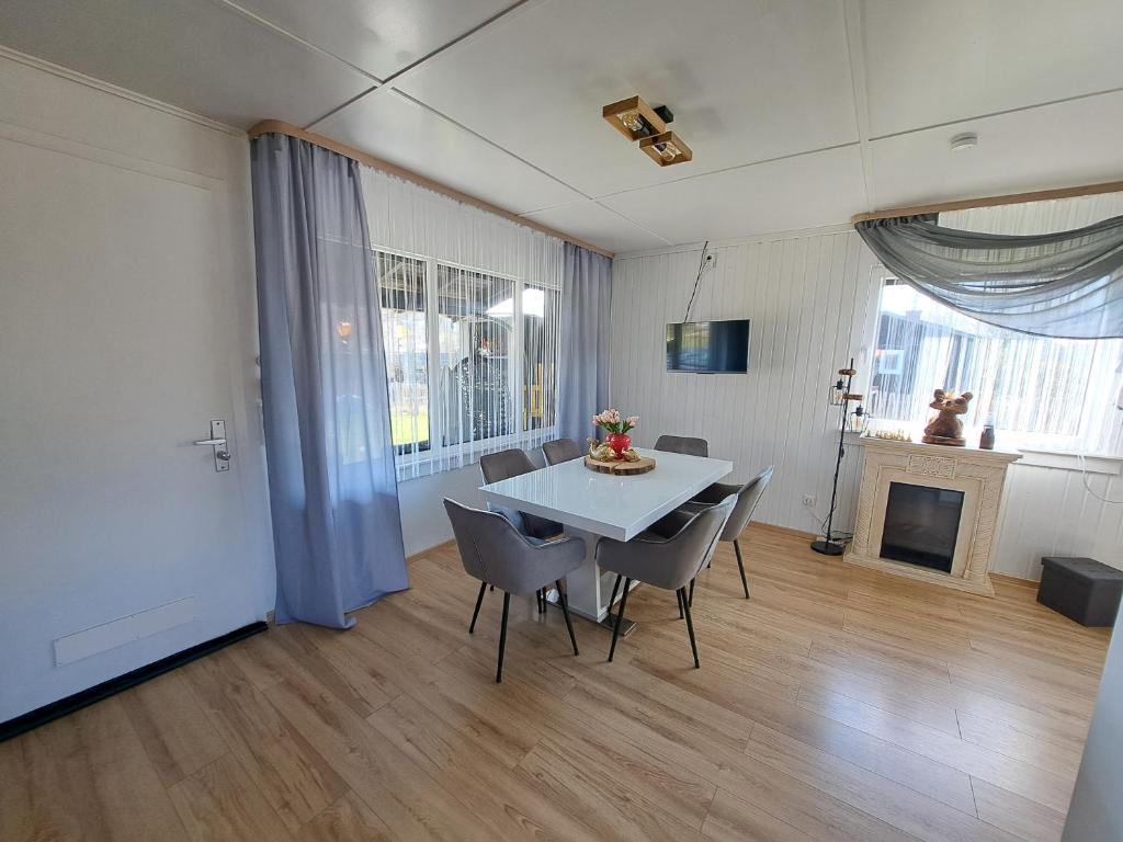 a dining room with a white table and chairs at Ferienhaus am Edersee-scheid in Waldeck