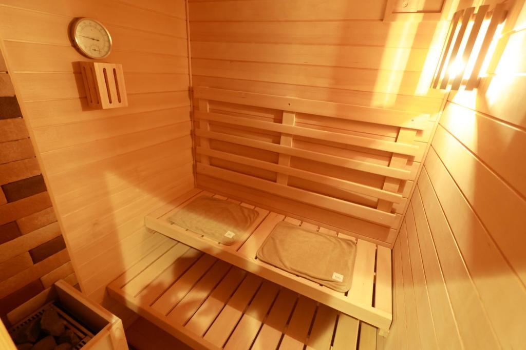 an inside view of a sauna with a clock at muniyuitsu 宮古島 spa&park in Miyako-jima