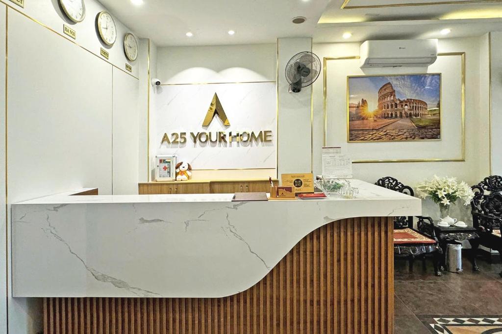 a reception desk in a room with aasurance sign on the wall at A25 Hotel - 57 Quang Trung in Hanoi