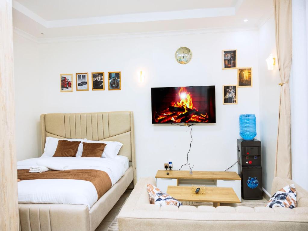 a bedroom with two beds and a fire on the wall at Epitome Luxe Homes near UN Gigiri and Two Rivers Mall in Ruaka