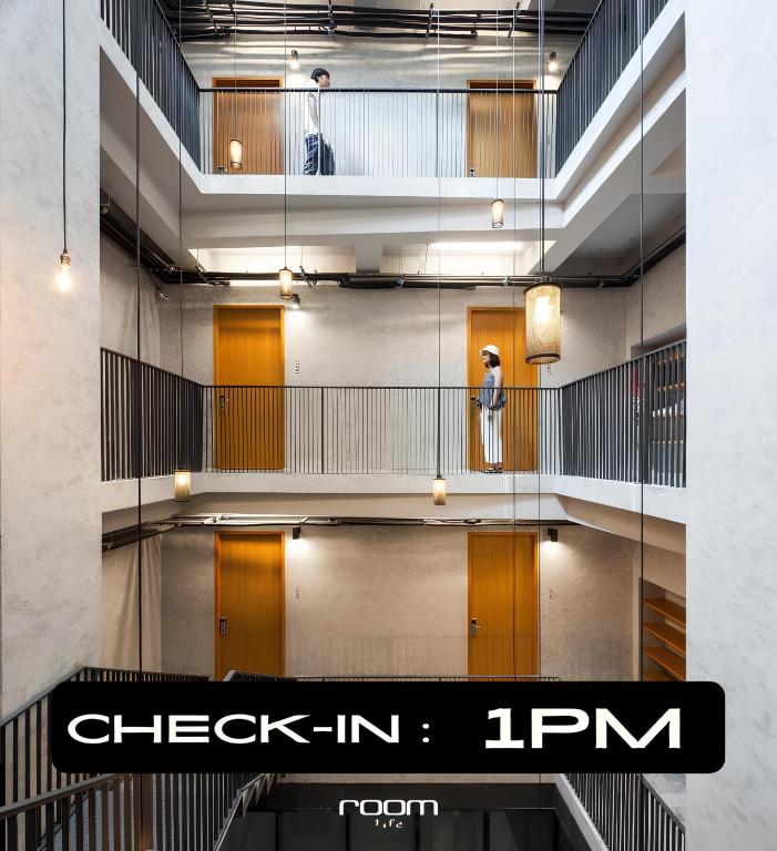 a person standing on a staircase in a building at Luk Hostel in Bangkok