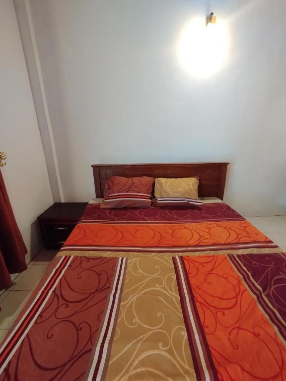 a bed in a small room with at NS Apartments in Dalugama