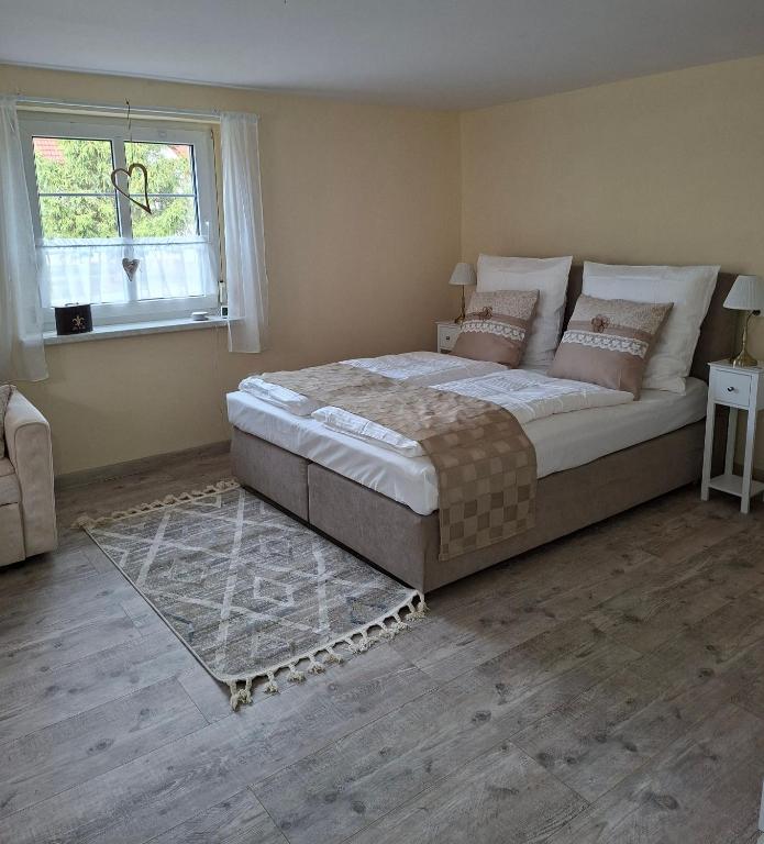 a bedroom with a large bed and a window at Ellens Farm in Kolkwitz