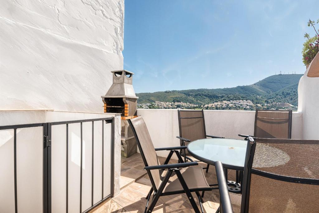 a patio with a table and chairs on a balcony at Mirasol in Benitachell