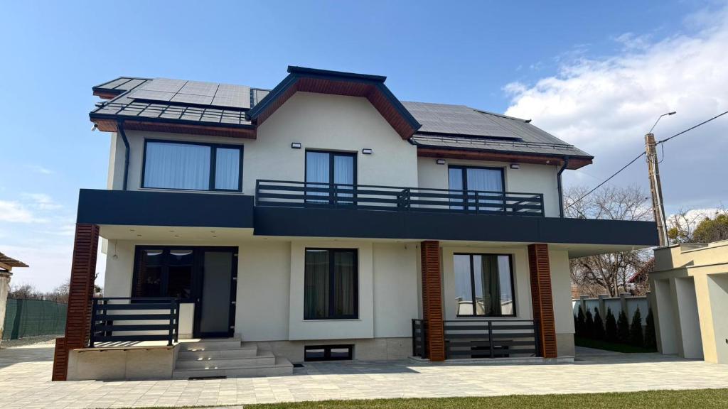a house with solar panels on the roof at Pensiunea SOLEA in Ucea de Jos