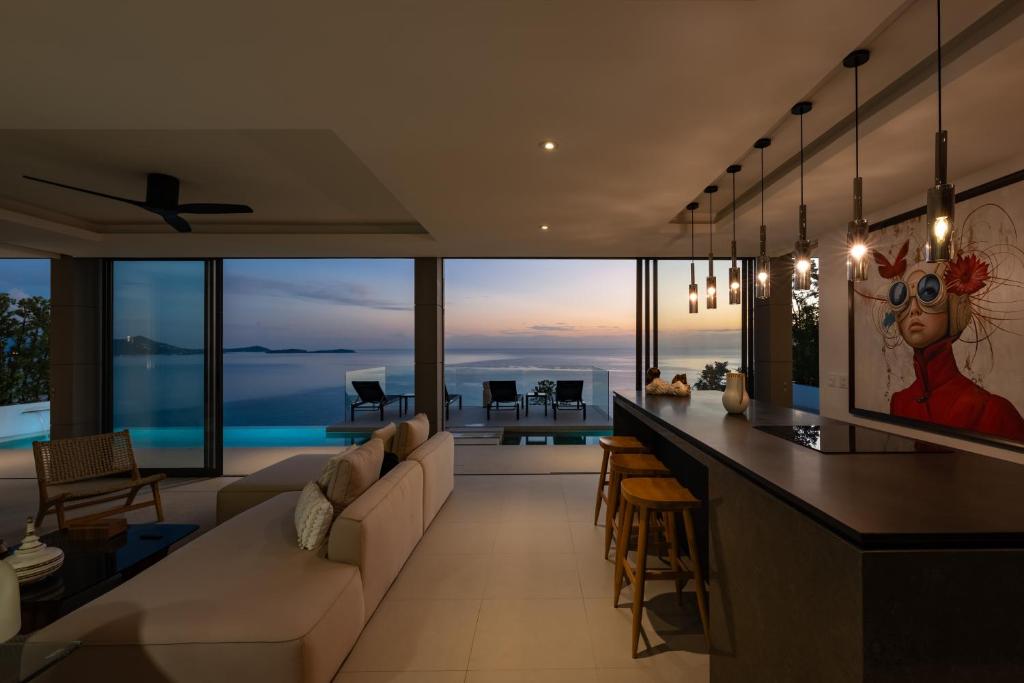 a living room with a couch and a bar at Sukkho Samui Estates in Chaweng Noi Beach