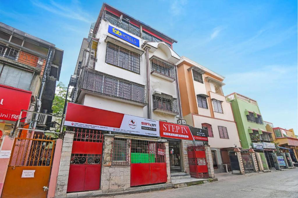 a building with red doors on the side of a street at FabHotel Step Inn Stays in Ballygunge