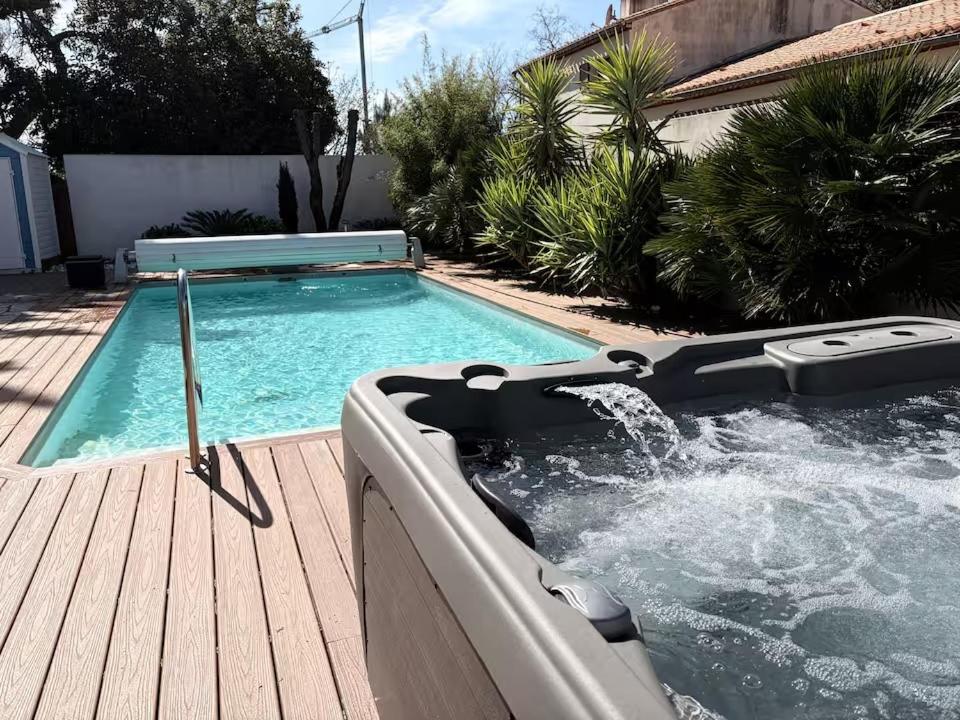a swimming pool with a hot tub on a deck at Villa à Brétignolles avec piscine chauffée et SPA à plus de 34 degrès in Bretignolles-sur-Mer