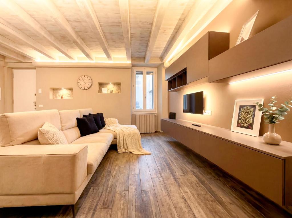a living room with a couch and a tv at Iseo Lake Luxury Duplex - Centro & Design in Iseo