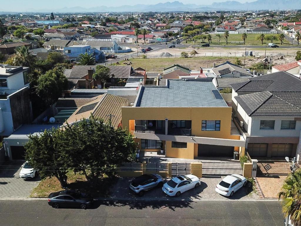 an aerial view of a house with cars parked in a parking lot at Camdale Guesthouse in Cape Town