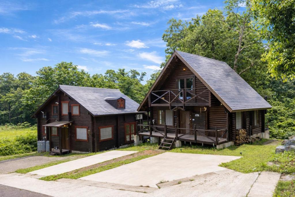 a log home with a gambrel roof at green bell in Myoko