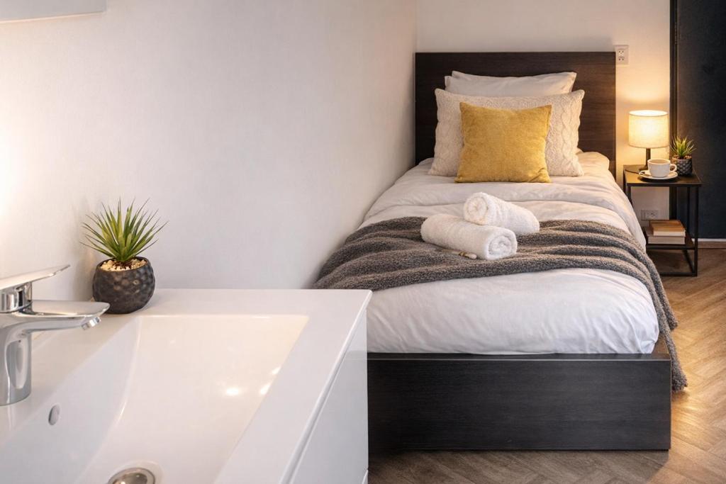 a bedroom with a bed and a bathtub at Budget-Friendly Room Tilburg Center Prime Loc in Tilburg