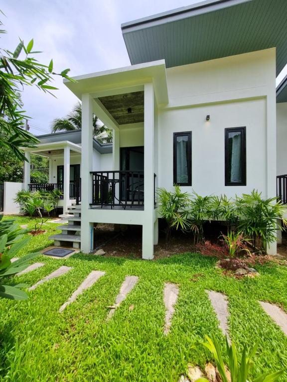 a house with a green roof at Nua Tone Riverside in Thalang