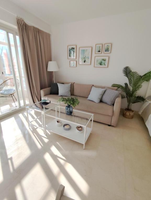 a living room with a couch and a table at Estudio Puerto de Sotogrande in Sotogrande