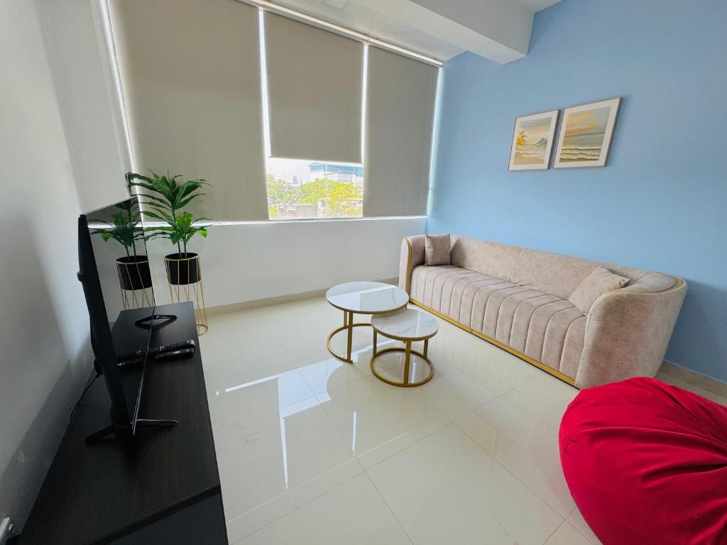 a living room with a couch and a table at The Colombo Charm in Colombo