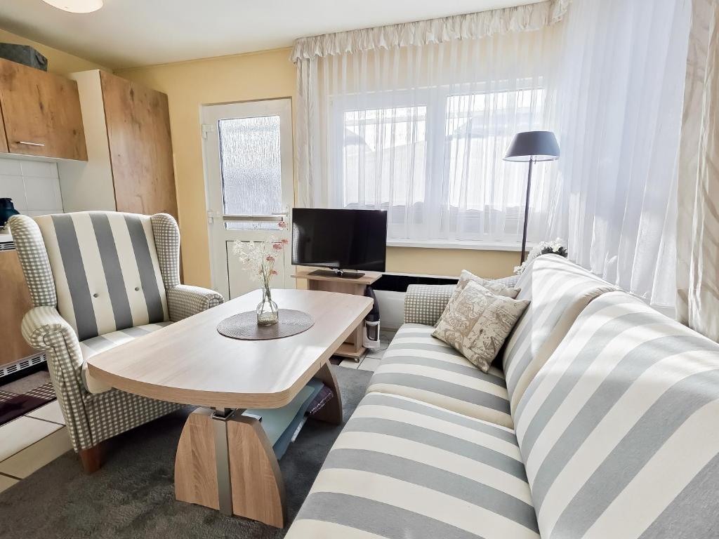 a living room with a couch and a table at Stettiner Str 6c in Grömitz
