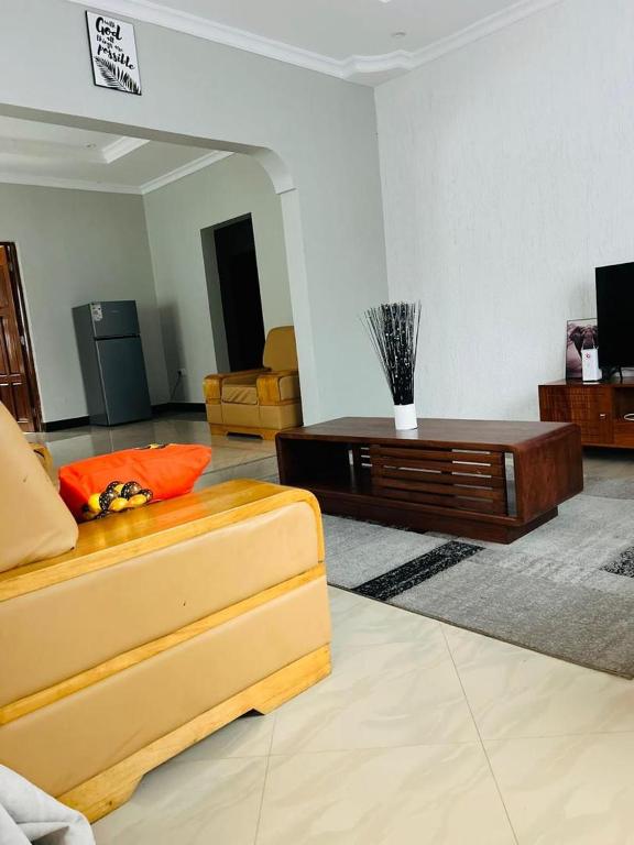 a living room with a couch and a coffee table at Olive homes in Nkunjila