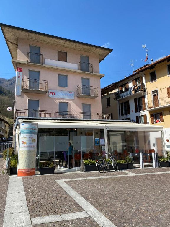 a building with a bike parked in front of it at Moderno Albergo Didattico in San Pellegrino Terme