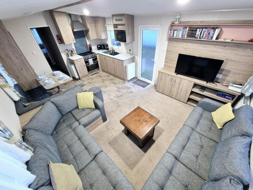 a large living room with a couch and a table at Birchington Vale - Trieste Sleeps 6 in Westgate-on-Sea