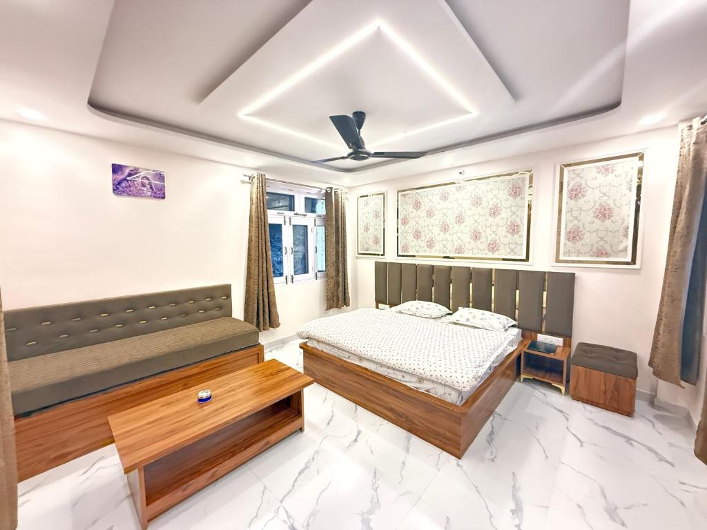 a bedroom with a bed and a couch at SanjayHomestay in Rāmpur