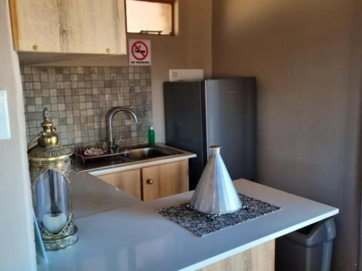 a kitchen with a sink and a refrigerator at Tented Camp in Augrabies in Kakamas