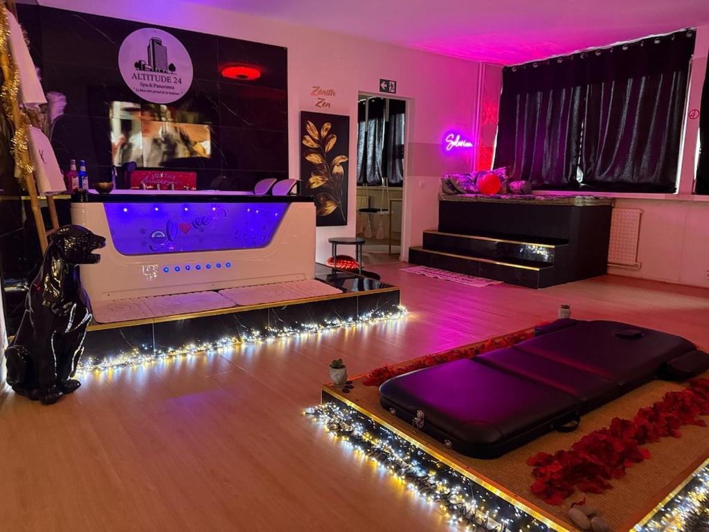 a room with a bed in a dance floor with lights at Altitude 24 Panorama and Spa in Mulhouse