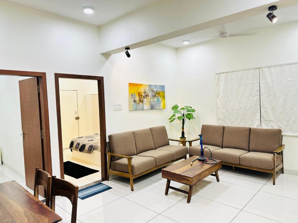 a living room with two chairs and a mirror at LaBelle Haven Aesthetic Cozy 2BHK For Family and Couples in Indore