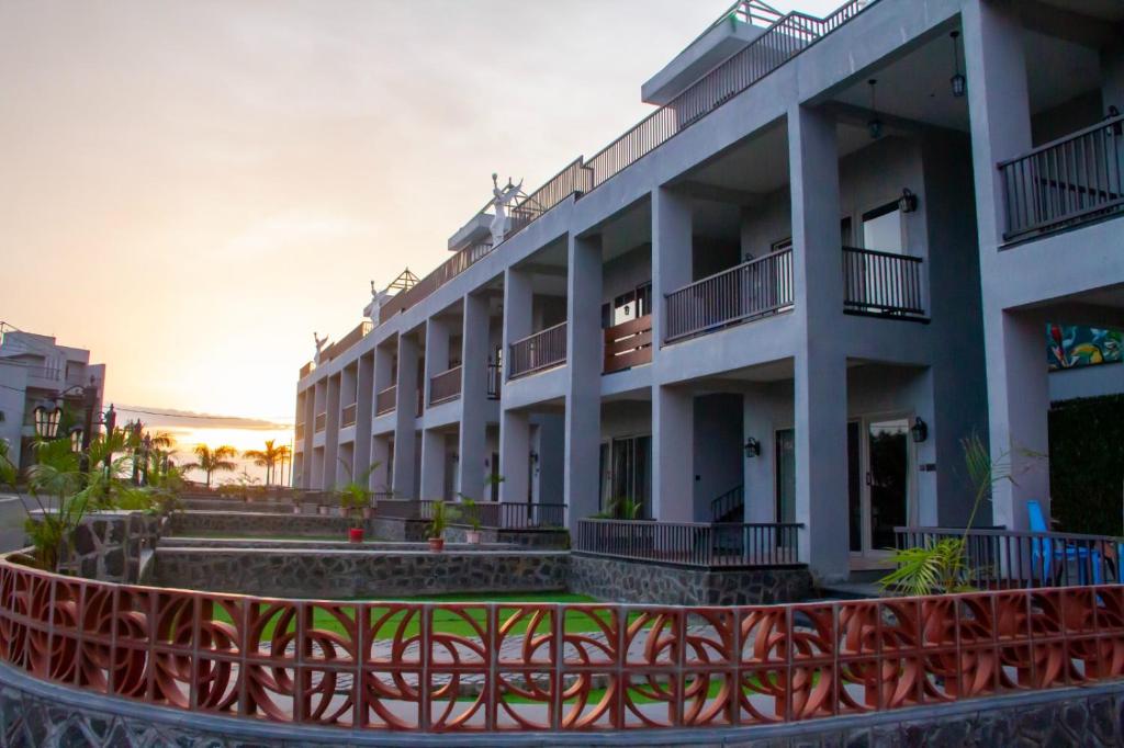 a building with a red fence in front of it at Shriji Ananda Hotel & Resort in Dhār