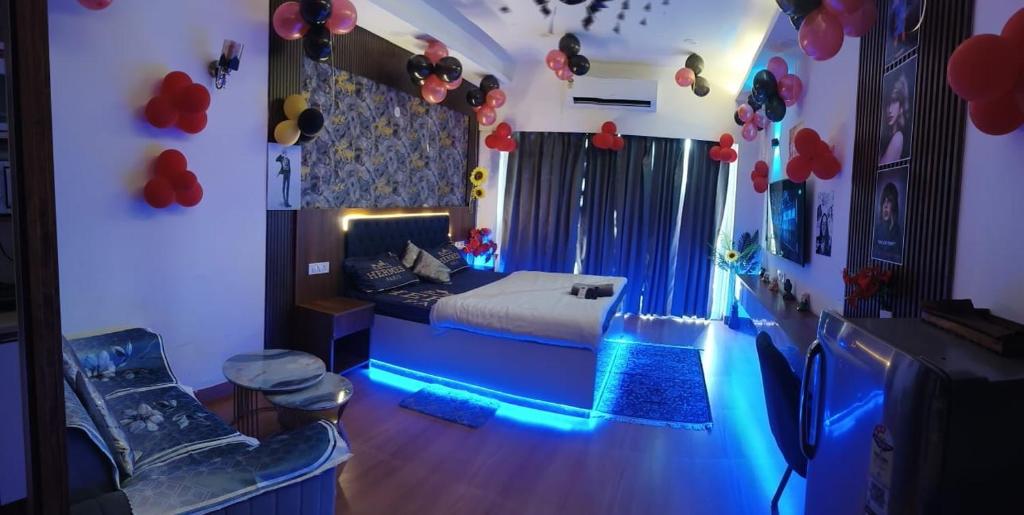 a bedroom with a bed with blue lights in it at Caelume Luxury Studios in Ghaziabad
