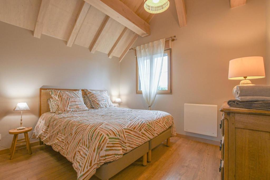 a bedroom with a bed and a window at La ferm'hier in Balnot-sur-Laignes
