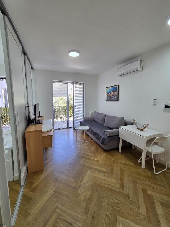 a living room with a couch and a table at Luxury flat Boka Nest in Dobrota